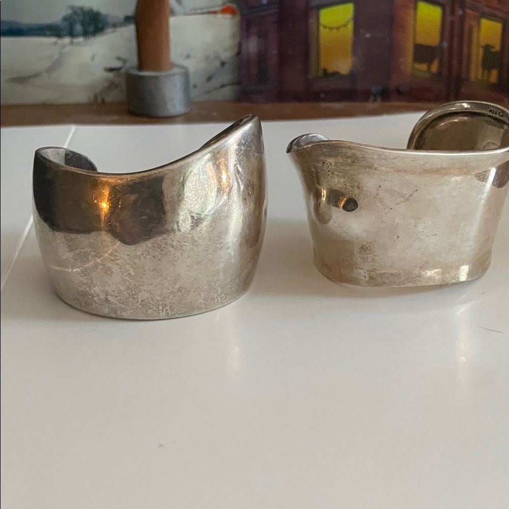 Silver Cuff Bracelets ($40 each) modern cuffs approx. 2” thick.